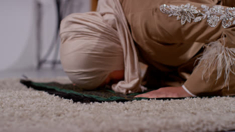 Close-Up-Of-Muslim-Woman-Wearing-Hijab-At-Home-Praying-Kneeling-On-Prayer-Mat-4